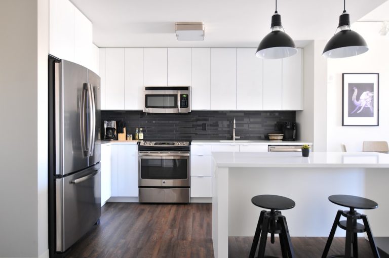 Kitchen with refrigerator, oven, and microwave