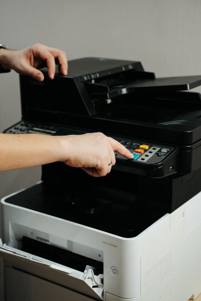 Hands servicing an office printer